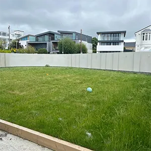 a ball is in the grass near a fence