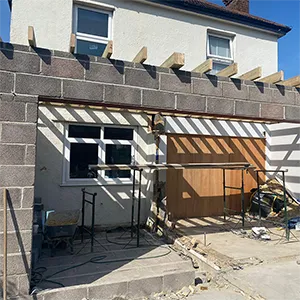 a house that is under construction with a wooden door