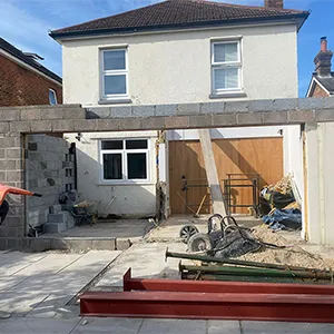 a house being built with a red bench in front of it