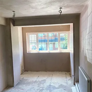 an empty room with a window and a radiator