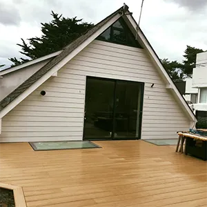 a house with a deck and a picnic table